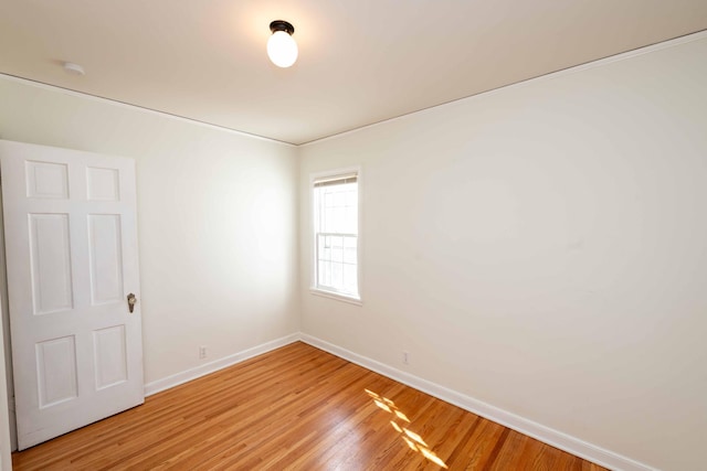 empty room with light wood-type flooring and baseboards