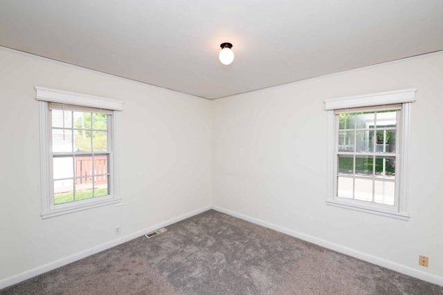 spare room with carpet and baseboards