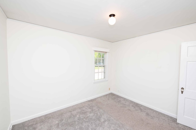 carpeted spare room with baseboards