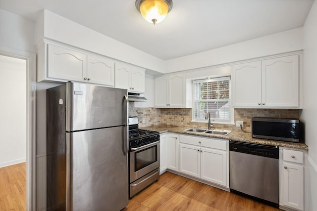 5341 Knox Ave S, Minneapolis, MN 55419 - kitchen with appliances with stainless steel finishes, a sink, under cabinet range hood, white cabinetry, and light wood finished floors