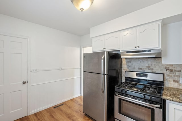 5341 Knox Ave S, Minneapolis, MN 55419 - kitchen with under cabinet range hood, stainless steel appliances, white cabinets, and tasteful backsplash