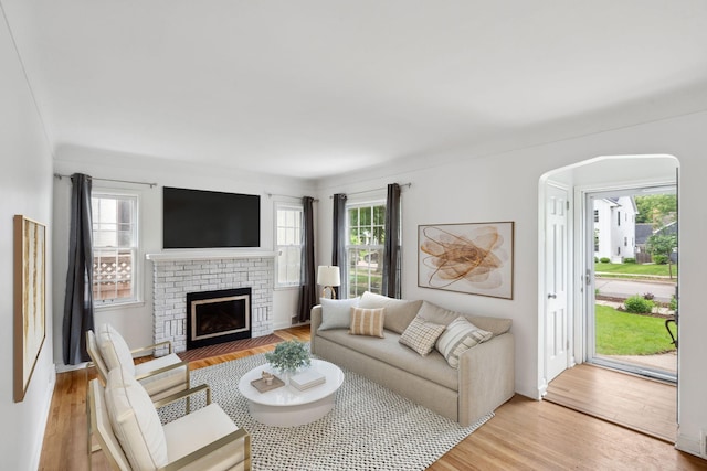 5341 Knox Ave S, Minneapolis, MN 55419 - living area featuring light wood-style floors, a brick fireplace, and arched walkways