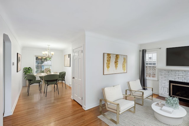 5341 Knox Ave S, Minneapolis, MN 55419 - living room with healthy amount of natural light, light wood-style flooring, a chandelier, and a fireplace