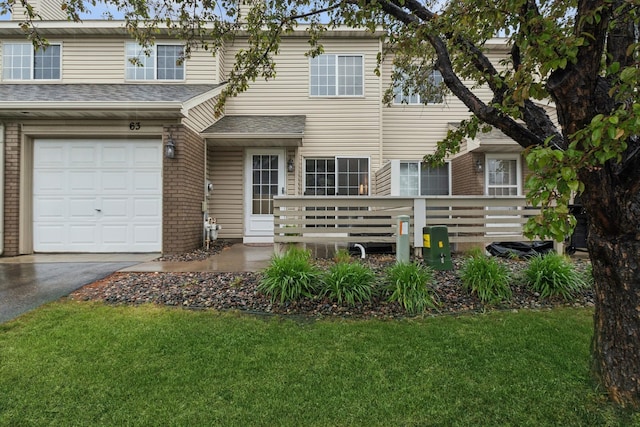 13210 Meadowood Trl NW Unit 63Nw, Coon Rapids, MN 55448 - multi unit property featuring an attached garage, a front lawn, and asphalt driveway