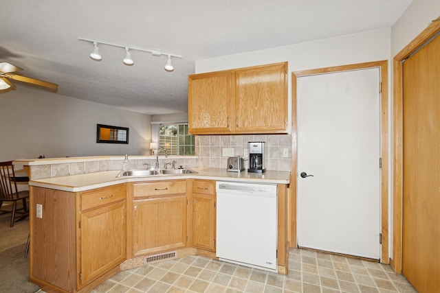 13210 Meadowood Trl NW Unit 63Nw, Coon Rapids, MN 55448 - kitchen featuring dishwasher, a sink, a peninsula, light countertops, and a ceiling fan