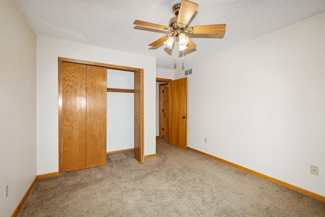 13210 Meadowood Trl NW Unit 63Nw, Coon Rapids, MN 55448 - unfurnished bedroom featuring carpet floors, baseboards, a closet, a textured ceiling, and a ceiling fan