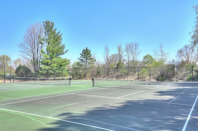 view of tennis court with fence