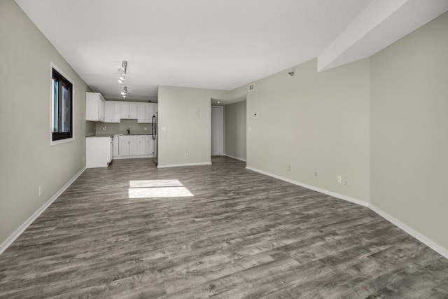 26 10th St W Unit 1701, Saint Paul, MN 55102 - unfurnished living room with dark wood-style flooring and baseboards