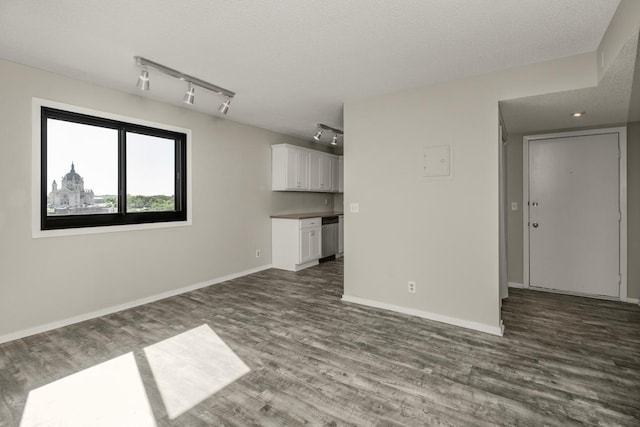 26 10th St W Unit 1701, Saint Paul, MN 55102 - unfurnished living room featuring rail lighting, dark wood finished floors, baseboards, and a textured ceiling