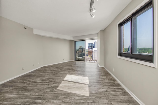 26 10th St W Unit 1701, Saint Paul, MN 55102 - unfurnished room featuring wood finished floors, baseboards, and track lighting