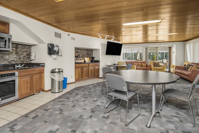 26 10th St W Unit 1701, Saint Paul, MN 55102 - dining space featuring wooden ceiling, light tile patterned flooring, and track lighting