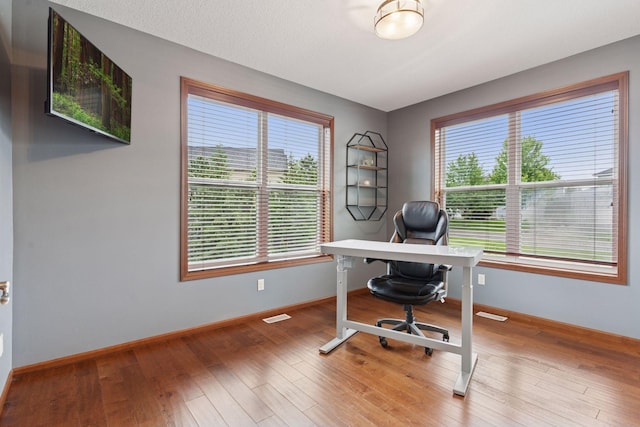 11200 Walnut Ln, Woodbury, MN 55129 - home office featuring baseboards and wood finished floors