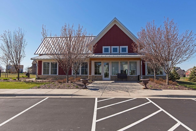 11200 Walnut Ln, Woodbury, MN 55129 - view of front of property with stone siding, a standing seam roof, and metal roof
