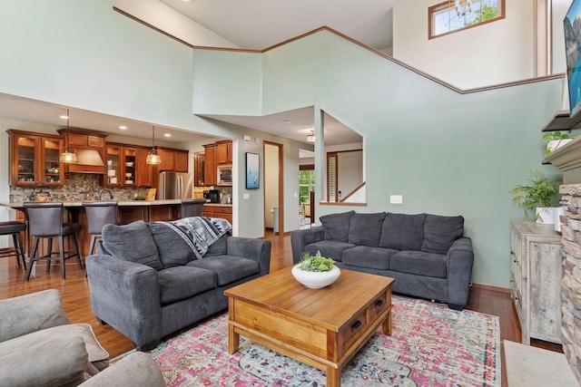11200 Walnut Ln, Woodbury, MN 55129 - living room featuring light wood finished floors, a stone fireplace, plenty of natural light, high vaulted ceiling, and recessed lighting
