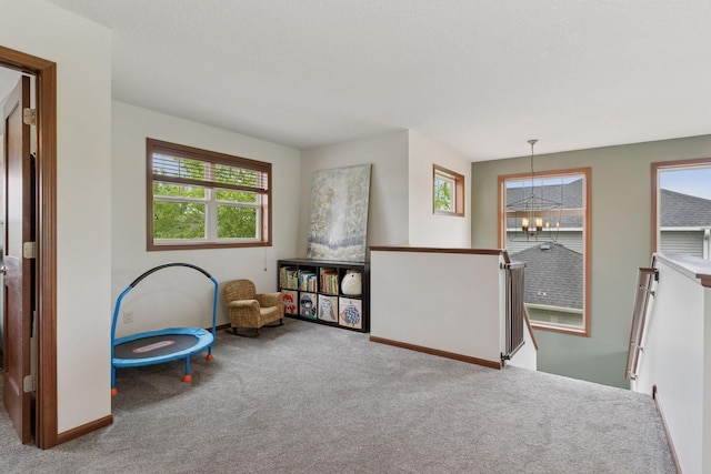 11200 Walnut Ln, Woodbury, MN 55129 - game room with carpet, a chandelier, and baseboards