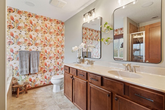 11200 Walnut Ln, Woodbury, MN 55129 - bathroom featuring toilet, double vanity, a shower, and wallpapered walls