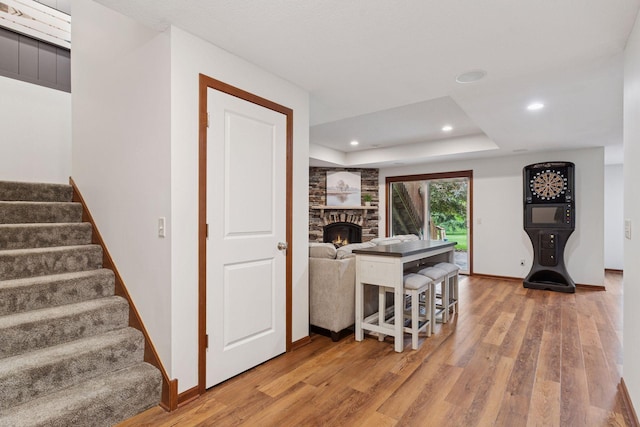 11200 Walnut Ln, Woodbury, MN 55129 - kitchen with light wood-style floors, a stone fireplace, baseboards, and recessed lighting