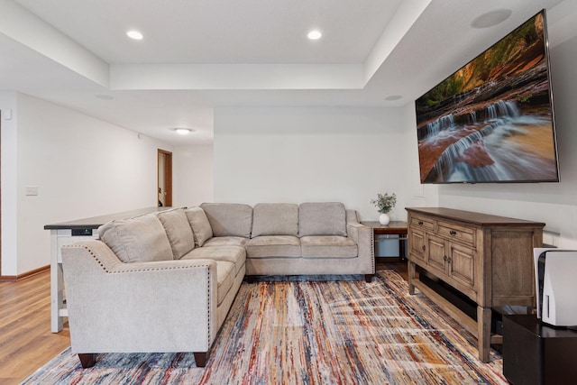 11200 Walnut Ln, Woodbury, MN 55129 - living area featuring wood finished floors, recessed lighting, a tray ceiling, and baseboards