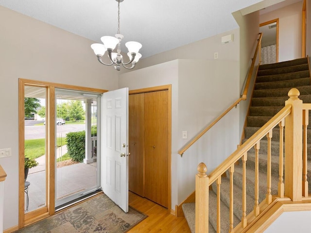 6700 210th Lane Cir N, Forest Lake, MN 55025 - entrance foyer with light wood-type flooring, a chandelier, and stairway