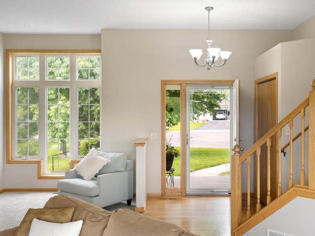 6700 210th Lane Cir N, Forest Lake, MN 55025 - entrance foyer featuring a chandelier, stairway, and light wood-style flooring