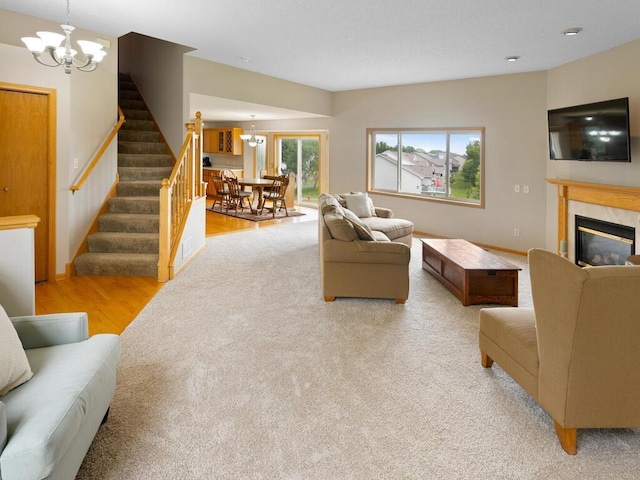 6700 210th Lane Cir N, Forest Lake, MN 55025 - living area with a chandelier, stairway, a high end fireplace, and light wood-style flooring