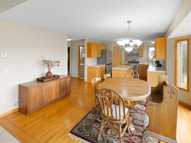 6700 210th Lane Cir N, Forest Lake, MN 55025 - dining space with a chandelier and light wood finished floors