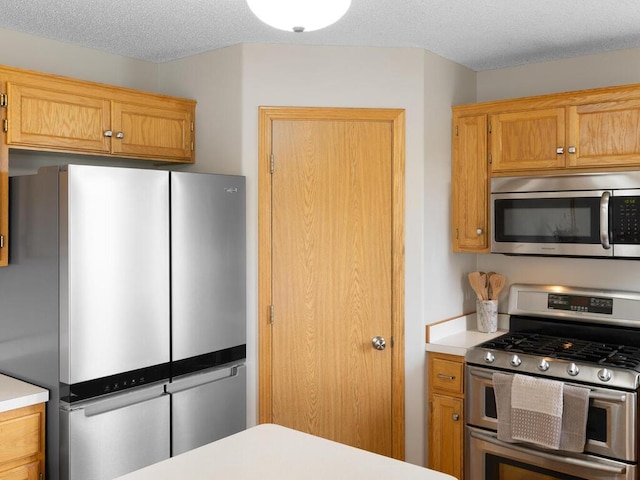 6700 210th Lane Cir N, Forest Lake, MN 55025 - kitchen with appliances with stainless steel finishes, light countertops, a textured ceiling, and brown cabinets
