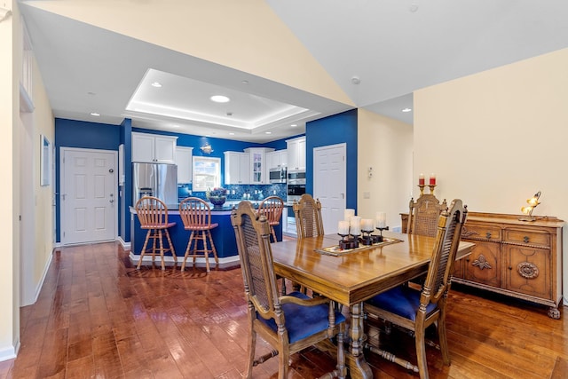 24064 Rivers Edge Rd, Rogers, MN 55374 - dining room featuring dark wood-type flooring, a raised ceiling, and baseboards