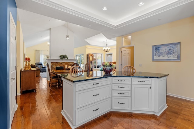 24064 Rivers Edge Rd, Rogers, MN 55374 - kitchen featuring a chandelier, dark wood finished floors, healthy amount of natural light, lofted ceiling, and recessed lighting