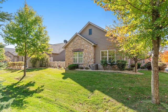 24064 Rivers Edge Rd, Rogers, MN 55374 - view of front of home featuring stone siding and cooling unit