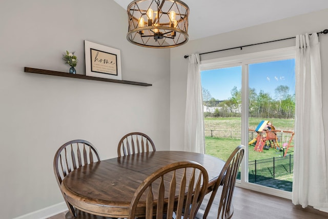 1120 7th Ave NE, Isanti, MN 55040 - dining space featuring wood finished floors and a chandelier