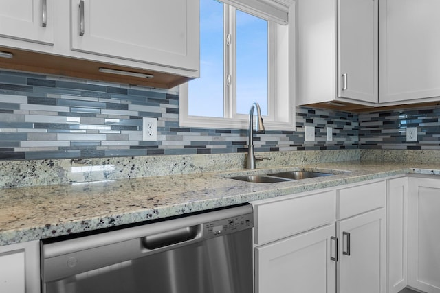 1120 7th Ave NE, Isanti, MN 55040 - kitchen featuring stainless steel dishwasher, white cabinets, backsplash, and light stone countertops