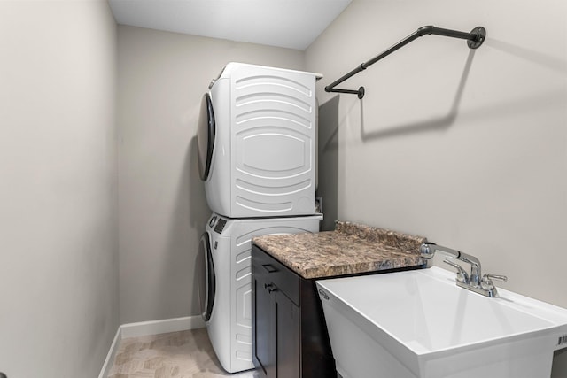 1120 7th Ave NE, Isanti, MN 55040 - laundry area with stacked washer and clothes dryer and cabinet space