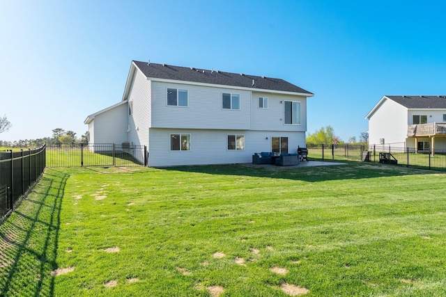 1120 7th Ave NE, Isanti, MN 55040 - back of house with a fenced backyard and an outdoor living space