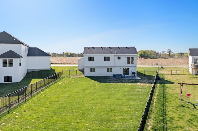 1120 7th Ave NE, Isanti, MN 55040 - back of property with a fenced backyard, a patio area, and a view of countryside