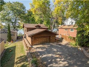 1555 Bluebird Ln, Mound, MN 55364 - view of side of home with fence and a detached garage
