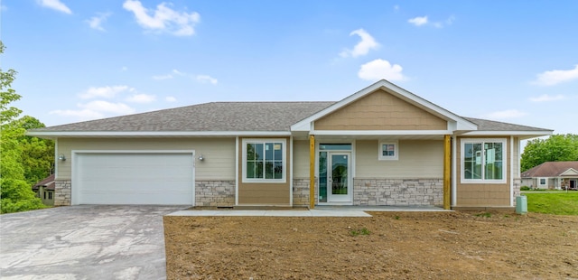 31079 Magnolia Ridge Way, Lindstrom, MN 55045 - view of front facade with stone siding, an attached garage, driveway, and roof with shingles