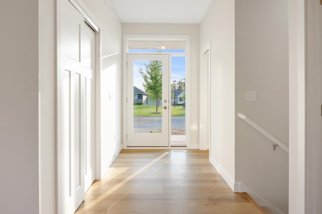 31079 Magnolia Ridge Way, Lindstrom, MN 55045 - doorway to outside featuring light wood finished floors and baseboards