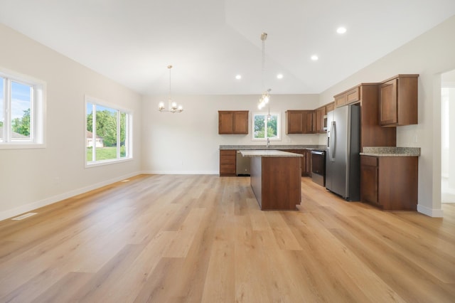 31079 Magnolia Ridge Way, Lindstrom, MN 55045 - kitchen featuring appliances with stainless steel finishes, a kitchen island, healthy amount of natural light, a chandelier, and lofted ceiling
