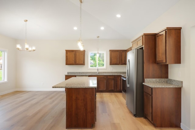 31079 Magnolia Ridge Way, Lindstrom, MN 55045 - kitchen with freestanding refrigerator, a center island, light wood-style flooring, decorative light fixtures, and recessed lighting