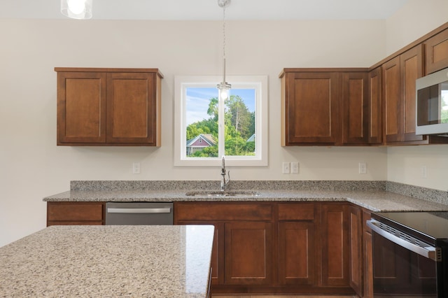 31079 Magnolia Ridge Way, Lindstrom, MN 55045 - kitchen with a sink, appliances with stainless steel finishes, decorative light fixtures, and light stone countertops