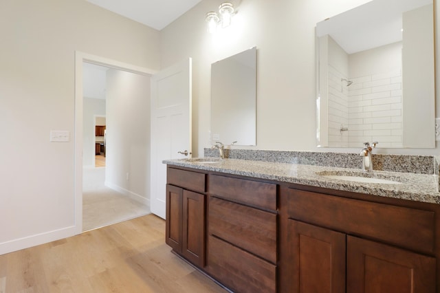 31079 Magnolia Ridge Way, Lindstrom, MN 55045 - full bath featuring double vanity, wood finished floors, tiled shower, and baseboards