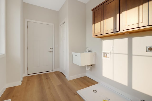 31079 Magnolia Ridge Way, Lindstrom, MN 55045 - laundry room featuring hookup for a washing machine, light wood-style floors, cabinet space, and baseboards