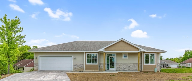 31079 Magnolia Ridge Way, Lindstrom, MN 55045 - view of front of house featuring a garage, concrete driveway, and stone siding