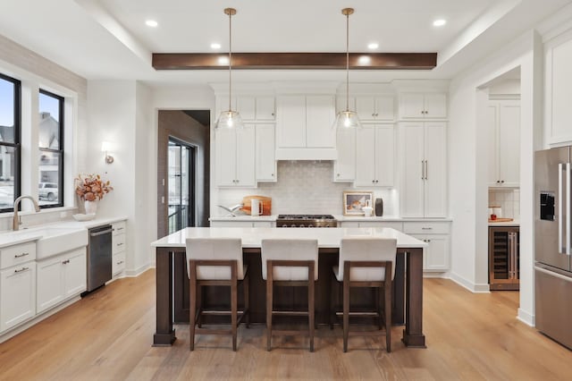 10320 Peony Ln N, Maple Grove, MN 55311 - kitchen featuring wine cooler, a sink, appliances with stainless steel finishes, light wood-style floors, and recessed lighting
