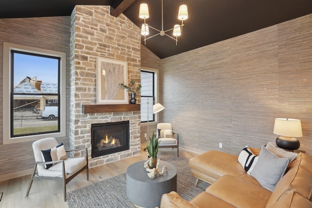 10320 Peony Ln N, Maple Grove, MN 55311 - living room with an outdoor stone fireplace, wood finished floors, beamed ceiling, a chandelier, and high vaulted ceiling