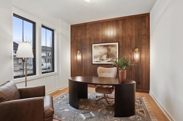 10320 Peony Ln N, Maple Grove, MN 55311 - home office featuring light wood-style floors, wooden walls, and baseboards