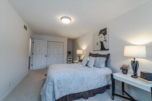 13721 Inglewood Ave, Savage, MN 55378 - bedroom with carpet floors, baseboards, a closet, and a textured ceiling