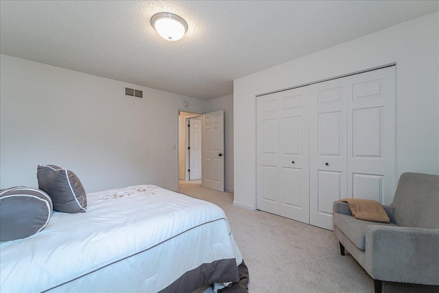 13721 Inglewood Ave, Savage, MN 55378 - bedroom with light carpet, a closet, and a textured ceiling