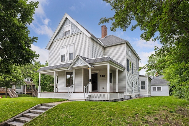 518 32nd St, Minneapolis, MN 55408 - view of front facade featuring a chimney, roof with shingles, a front yard, and a porch